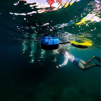 Diver using the BLU3 Nomad Mini Dive System underwater, with the system’s float visible on the surface, exploring the ocean